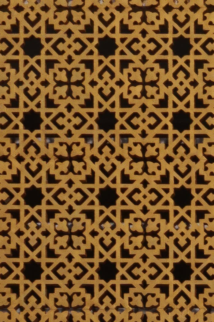 Close-up of a detailed Islamic geometric pattern showcasing intricate arabesque design and craftsmanship.